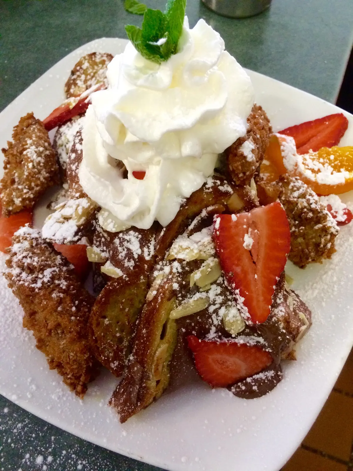 French toast topped with whipped cream and fruit at CJ's
