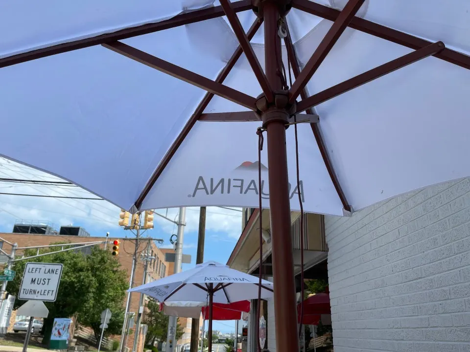 Outdoor tables and umbrellas at CJ's Corner Grill