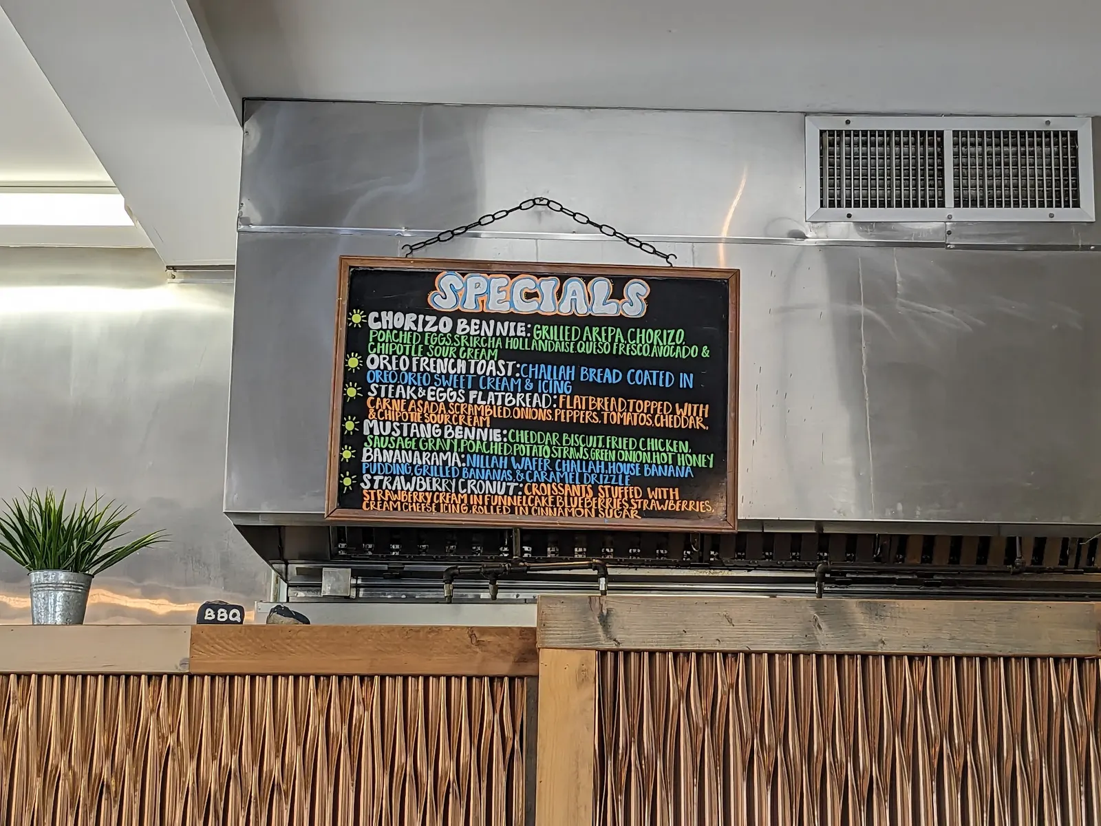 CJ's kitchen with its handwritten specials board and warm wood counter